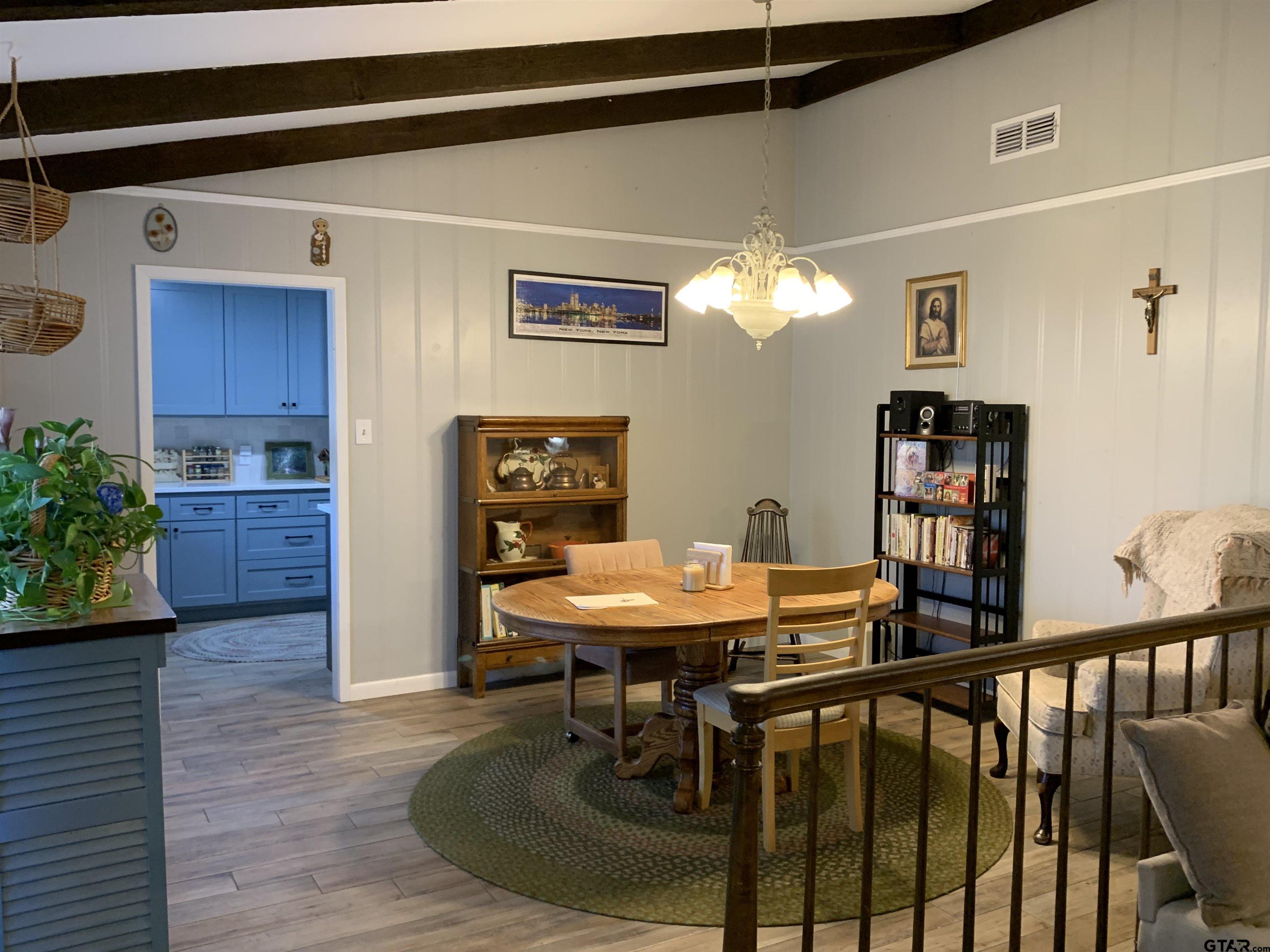 800 Neches Drive Tyler, TX 75702 - Photo 5 of 26 a view of a dining room with furniture and wooden floor