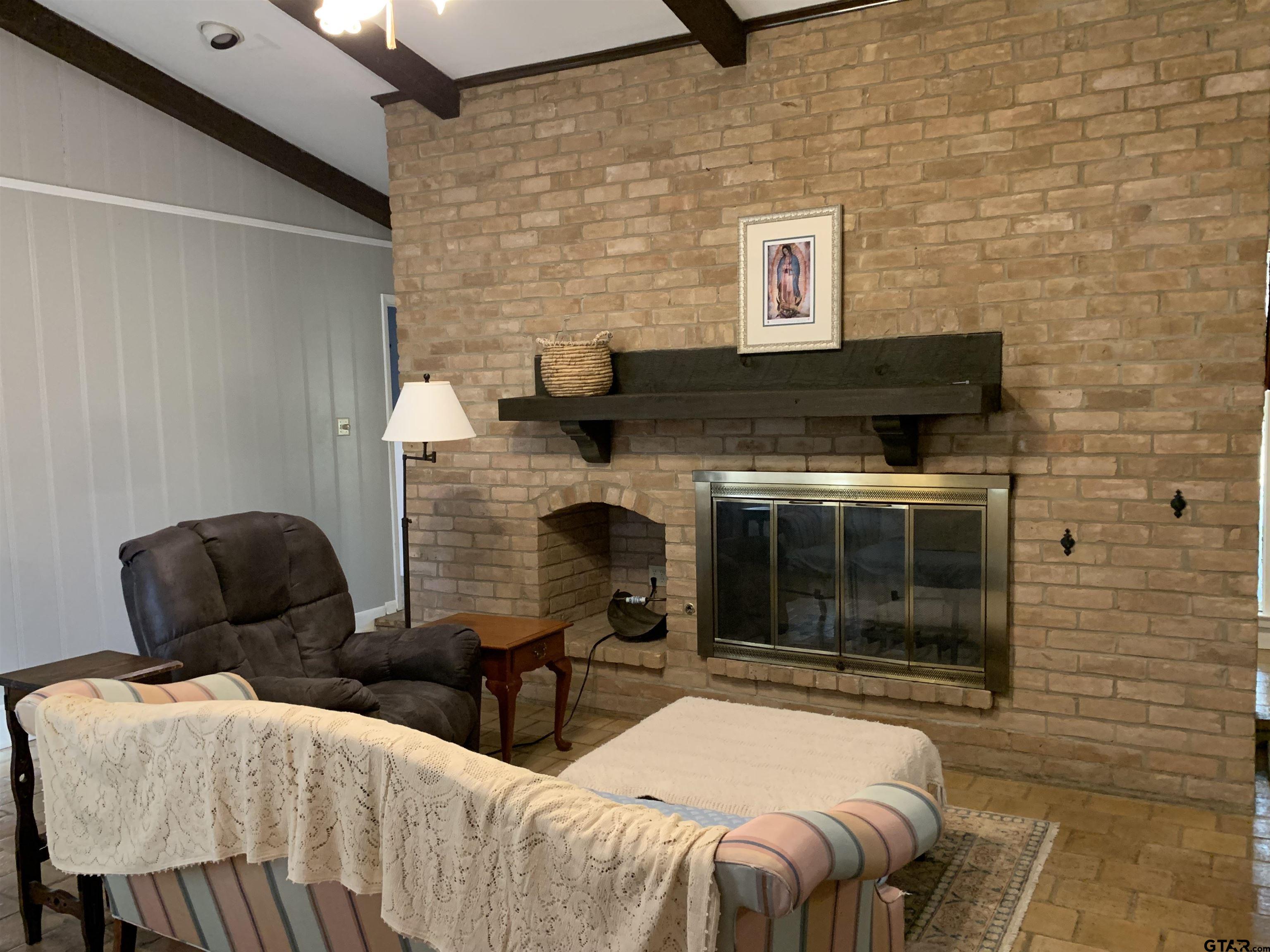 800 Neches Drive Tyler, TX 75702 - Photo 9 of 26 a living room with furniture and a fireplace