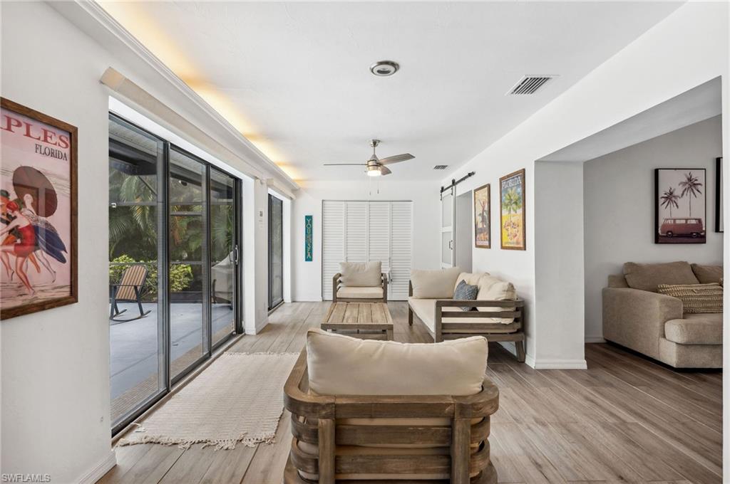118 Palmetto Dunes Circle Naples, FL 34113 - Photo 17 of 31 Florida room leading to pool. Access from Master bedroom, living area & family room