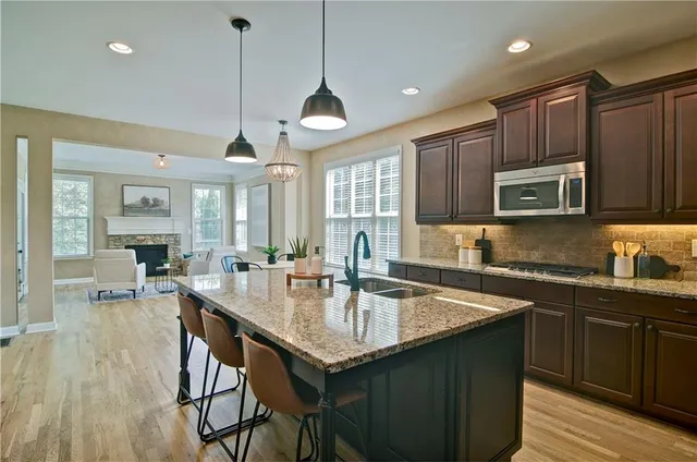 a kitchen with stainless steel appliances granite countertop a refrigerator and a sink