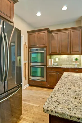 a living room with furniture a fireplace and a large window