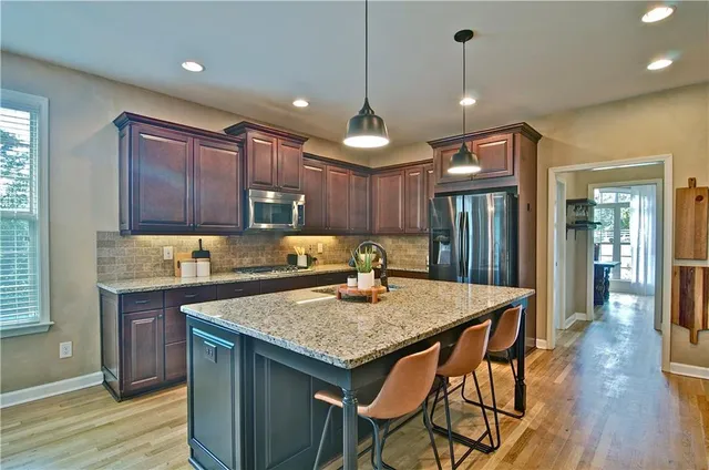 a living room with furniture a fireplace and a large window
