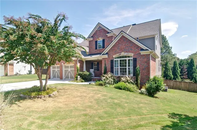 a front view of a house with garden