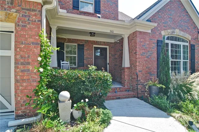 a view of a hallway with wooden floor and furniture