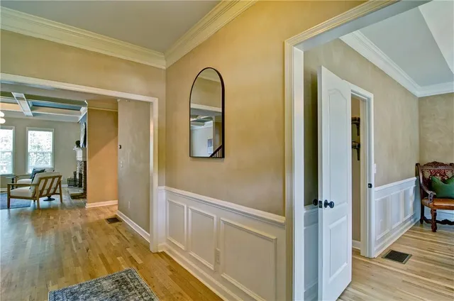 a dining room with furniture a chandelier and wooden floor