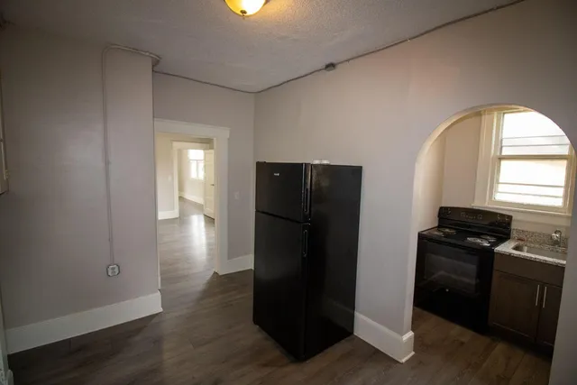 a kitchen with a refrigerator and a stove top oven