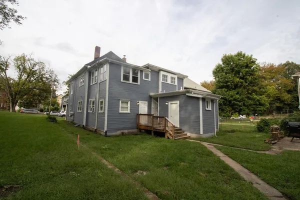 a front view of a house with a garden and yard
