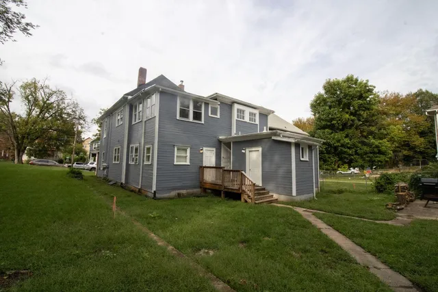 a front view of a house with a garden and yard