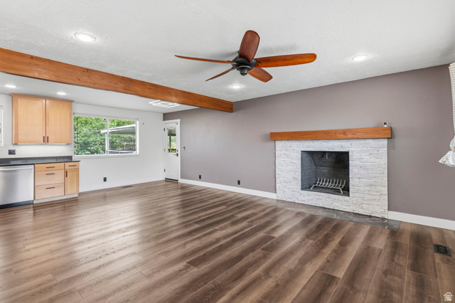 2693 Teal Way Sandy, UT 84093 - Photo 7 of 50 Spacious interior featuring wood-finish flooring, a white brick fireplace with a wood mantel, a ceiling fan, and recessed lighting