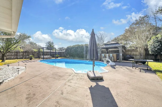 a view of a swimming pool with an outdoor space and seating area