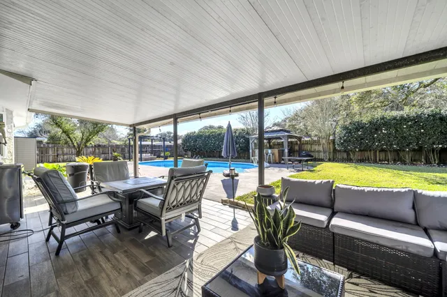 a dining room with furniture a fireplace and wooden floor