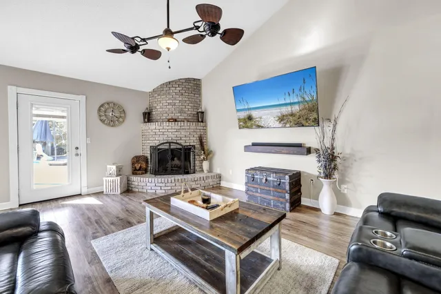 a living room with furniture a large window and a fireplace