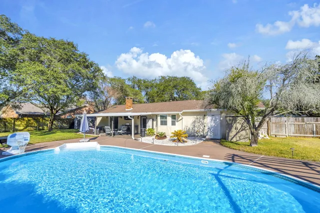 a view of a swimming pool with a patio