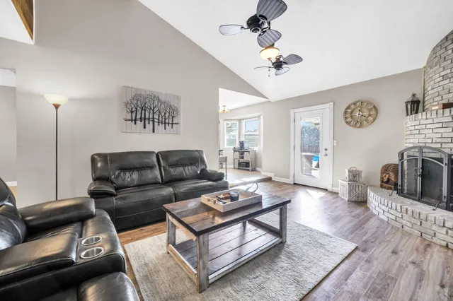 a living room with furniture a fireplace and a flat screen tv