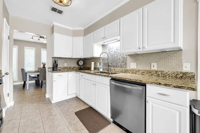a kitchen with stainless steel appliances white cabinets white stove a microwave and a refrigerator