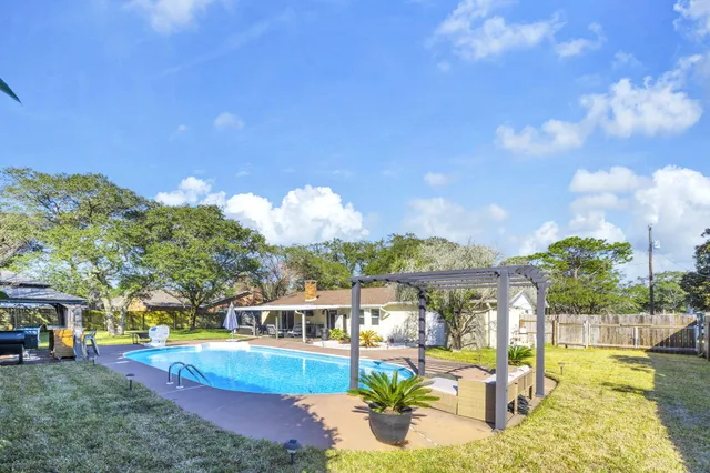 a front view of house with yard and trees around