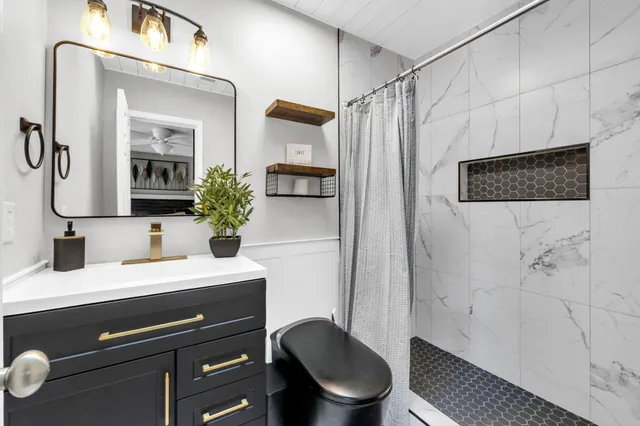 a bedroom with furniture and a window