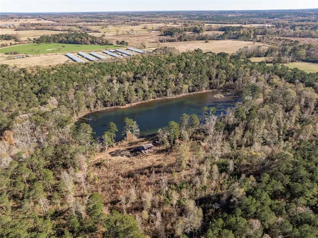 an aerial view of residential houses with outdoor space and river