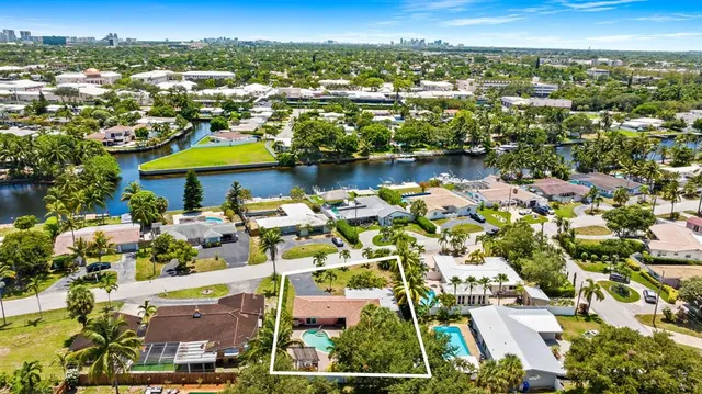 an aerial view of residential houses with outdoor space and swimming pool
