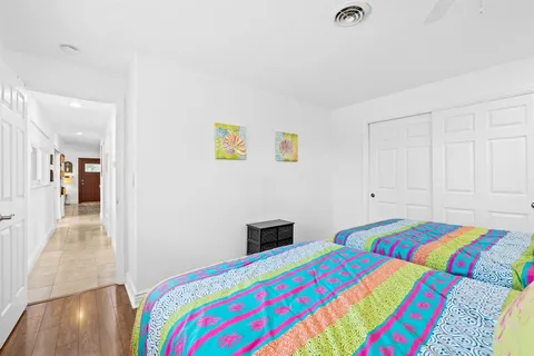 a bedroom with a bed and painting on the wall