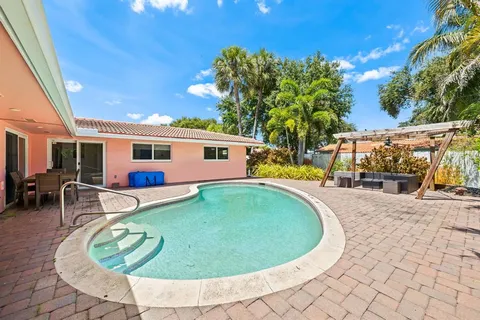 a view of a house with swimming pool and sitting area