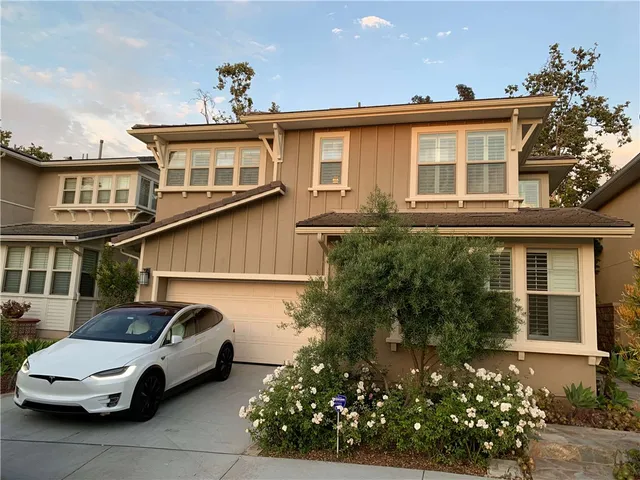 a car parked in front of a white house