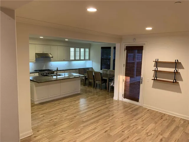 a kitchen with stainless steel appliances granite countertop a stove and a refrigerator