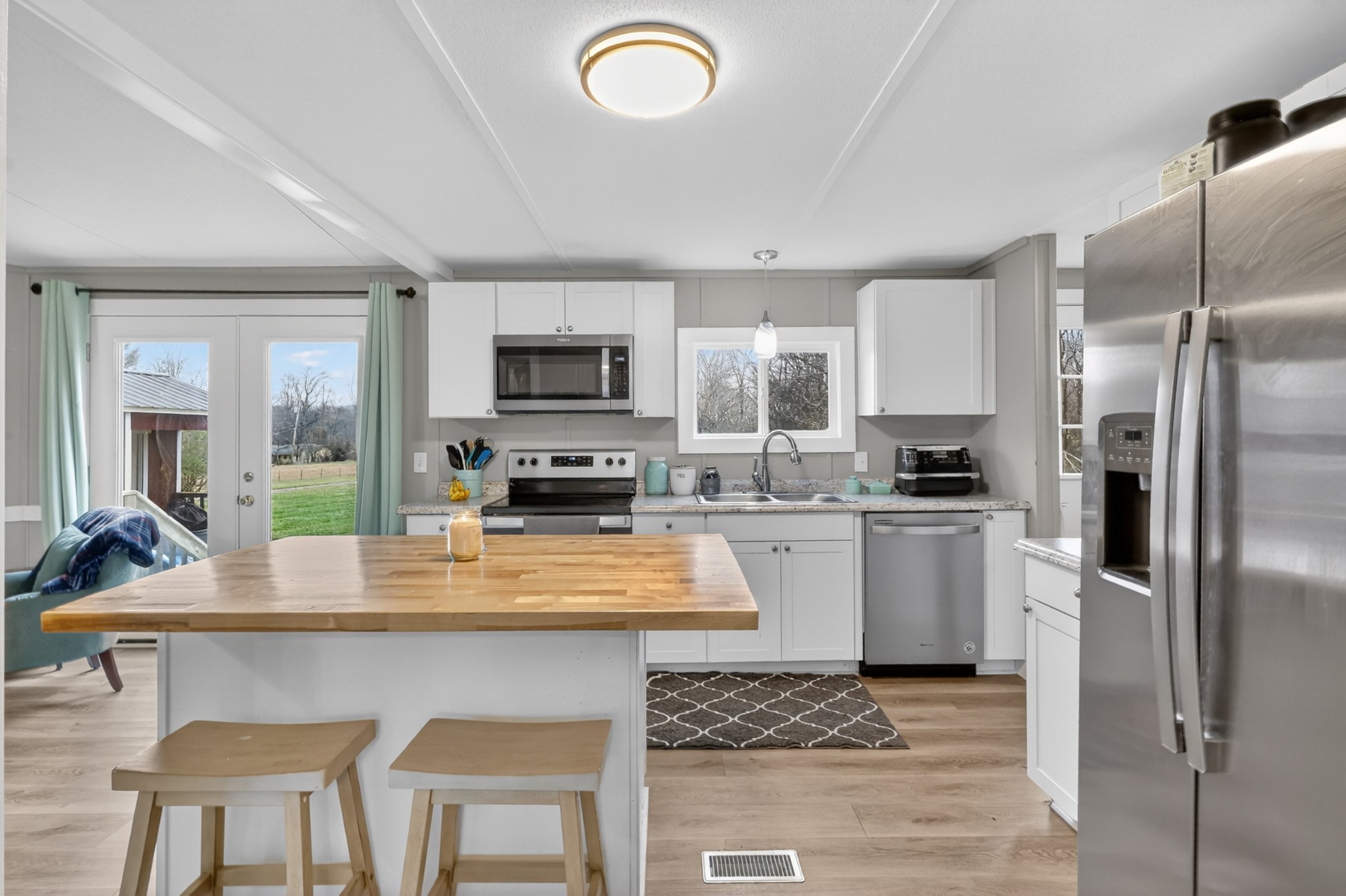 177 Mitchell Road Portland, TN 37148 - Photo 11 of 34 a kitchen with sink a refrigerator and chairs
