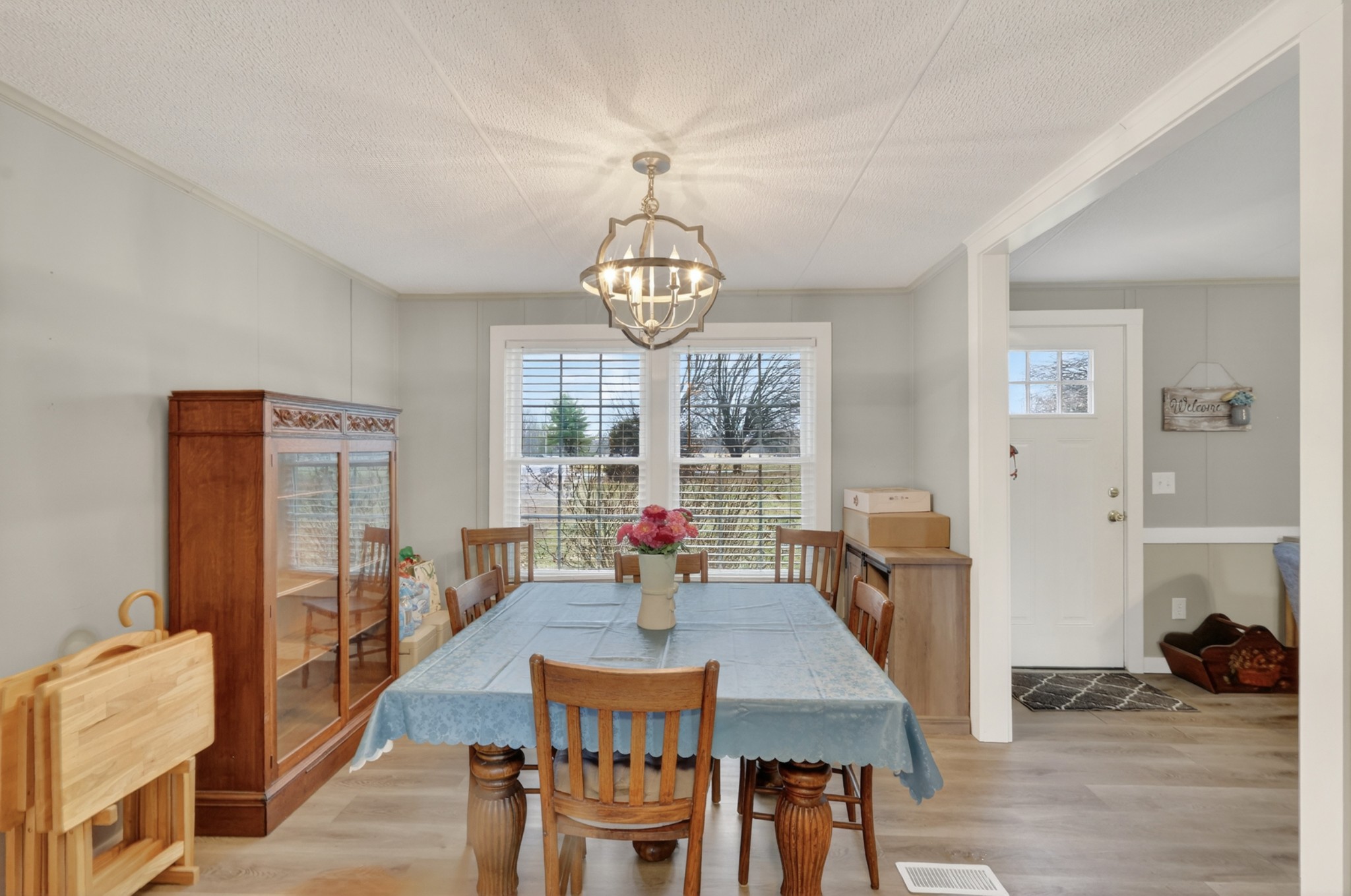 177 Mitchell Road Portland, TN 37148 - Photo 15 of 34 a view of a dining room with furniture a chandelier and wooden floor