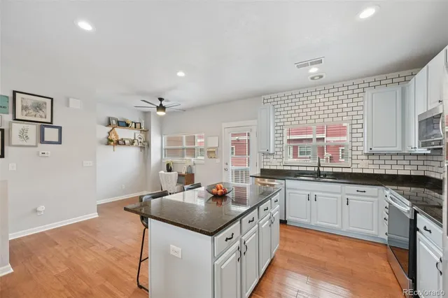 a kitchen with granite countertop a sink and cabinets