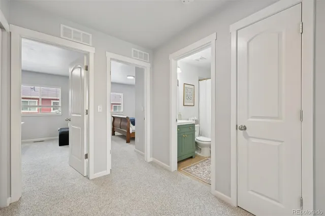 view of a livingroom with wooden floor and a bathroom