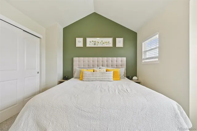 a bedroom with a bed and a painting on the wall