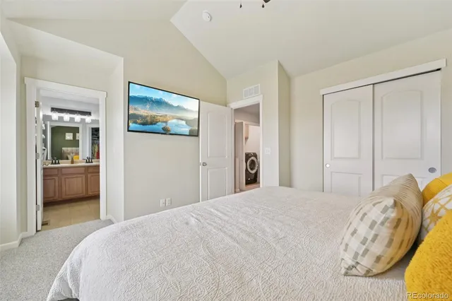 a bedroom with a large bed and a chandelier