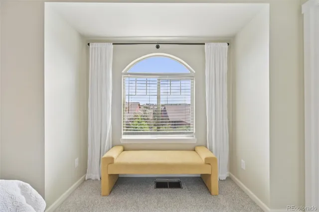 a spacious bedroom with a bed and a window