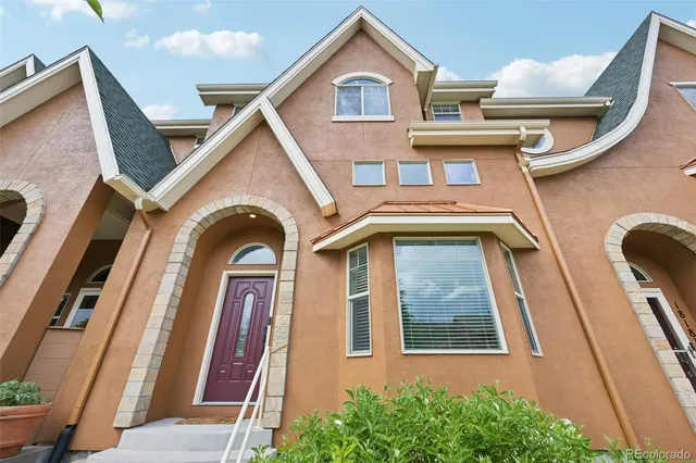 a view of a brick house with large windows