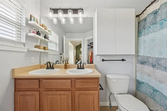 a bathroom with a toilet sink and mirror