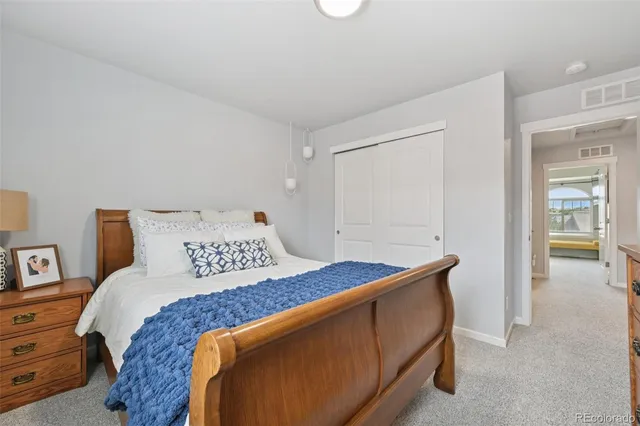 a bedroom with a bed and a table