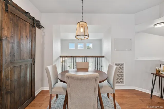 a view of a dining room with furniture window and wooden floor