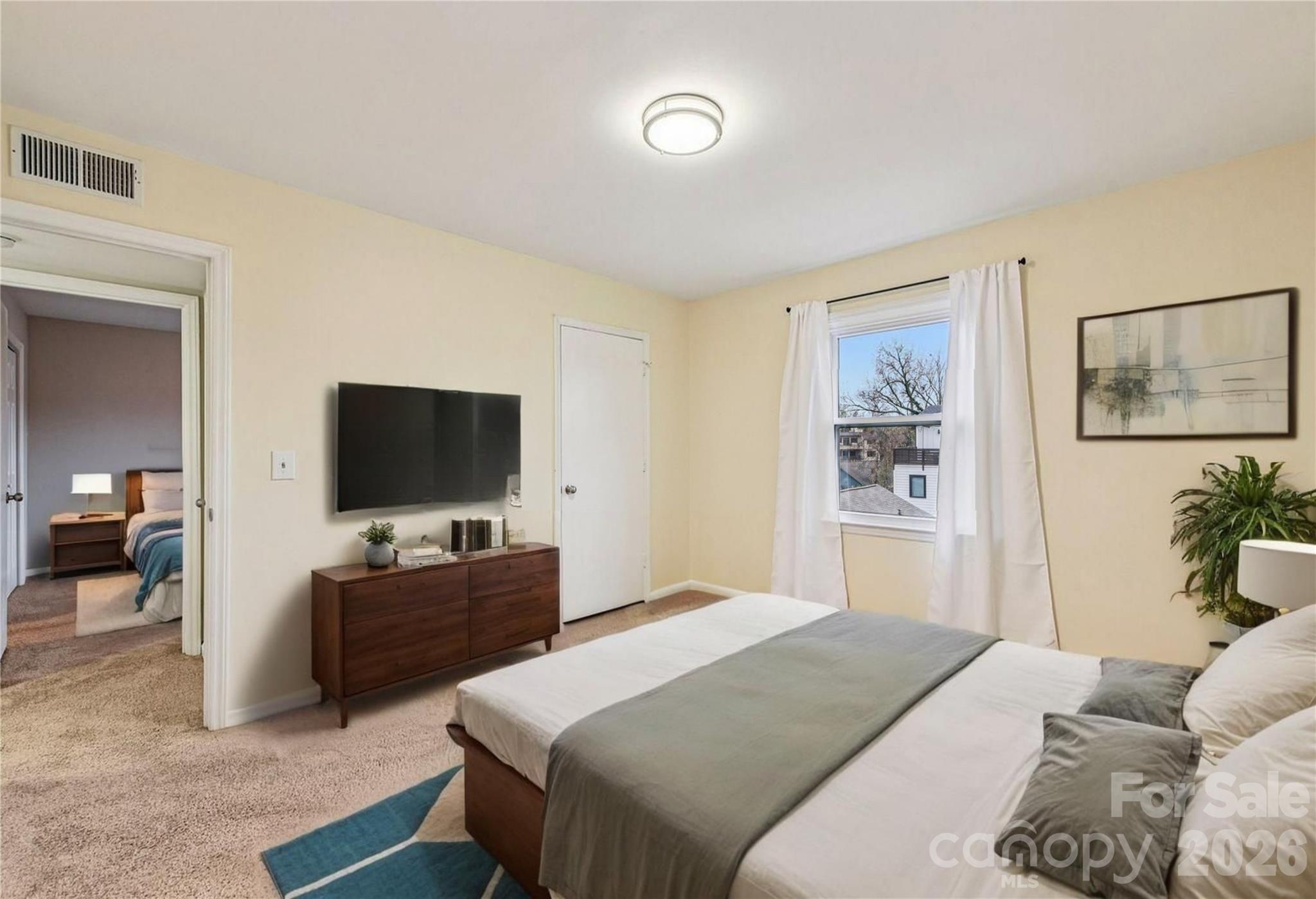 430 Queens Road, Unit 732 Charlotte, NC 28204 - Photo 11 of 17 a bedroom with a bed and a flat screen tv