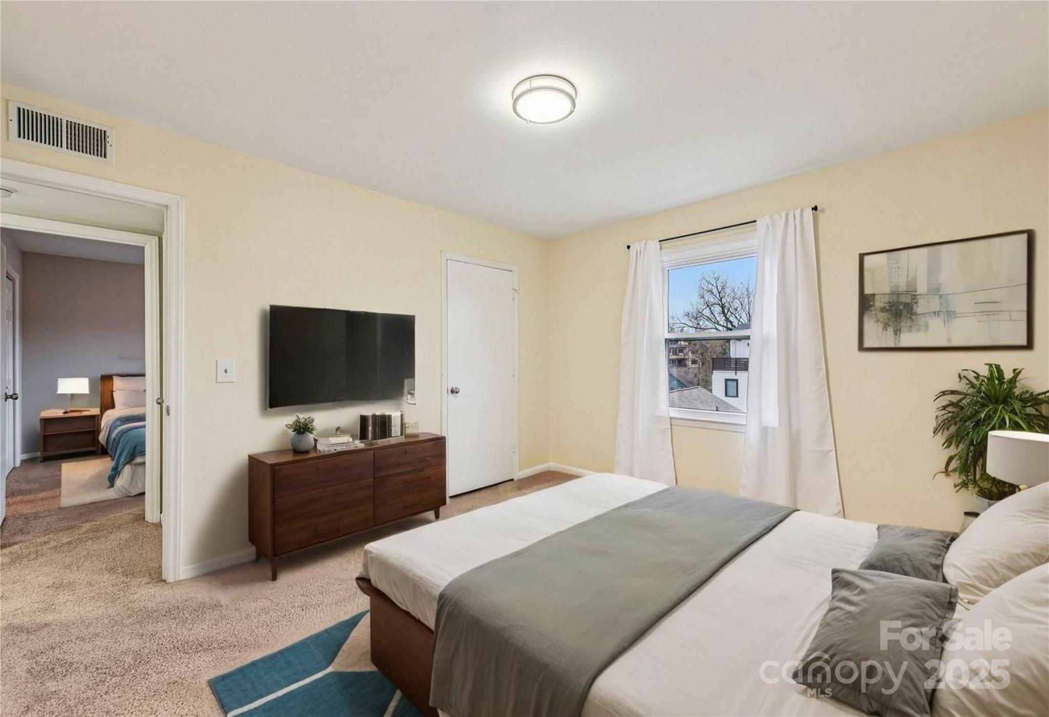 430 Queens Road, Unit 732 Charlotte, NC 28204 - Photo 11 of 17 a bedroom with a bed and a flat screen tv