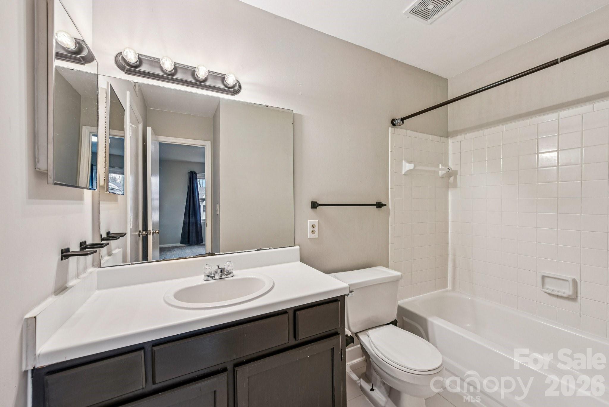 430 Queens Road, Unit 732 Charlotte, NC 28204 - Photo 13 of 17 a bathroom with a sink toilet vanity and shower