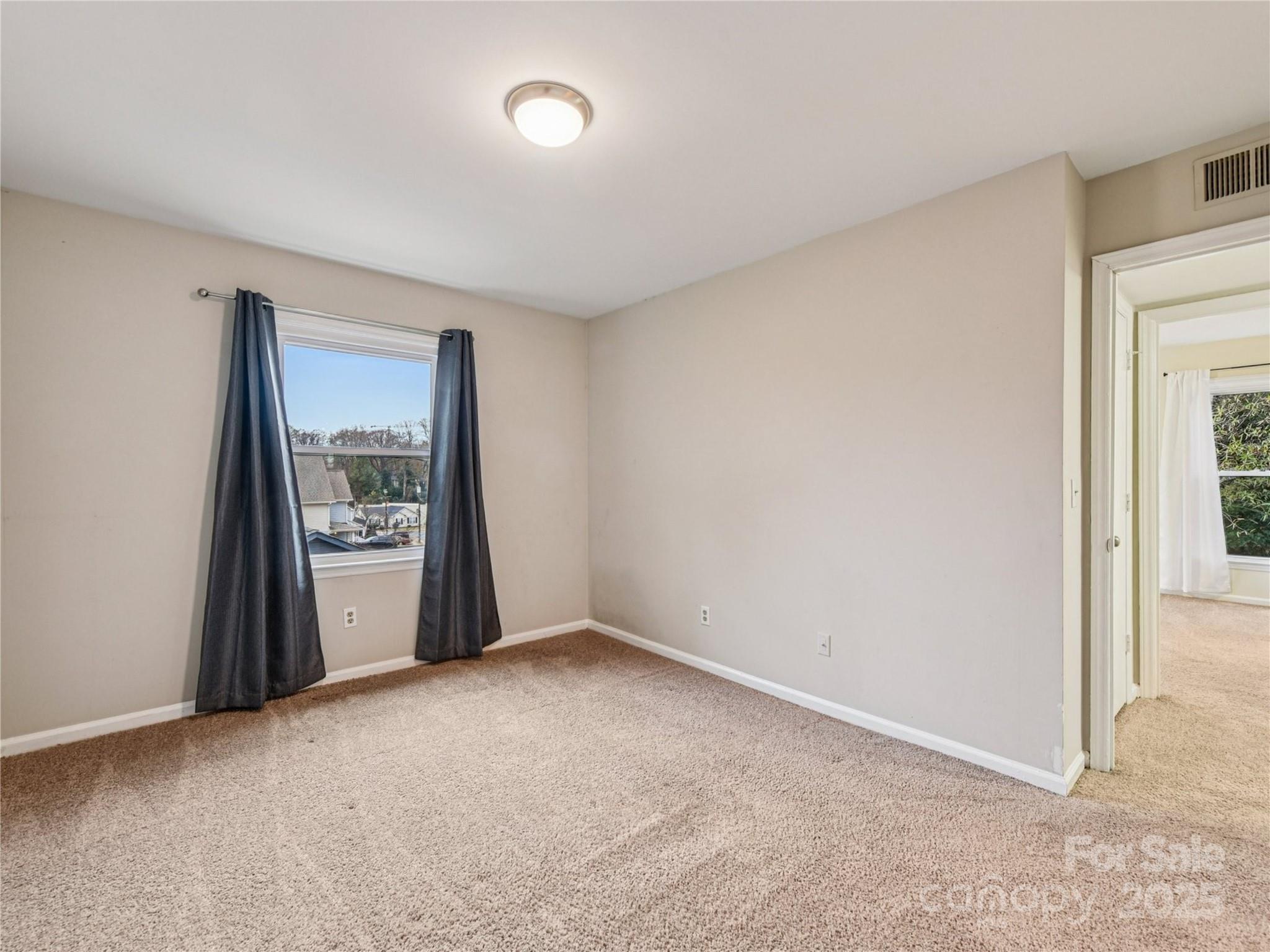 430 Queens Road, Unit 732 Charlotte, NC 28204 - Photo 14 of 17 an empty room with windows