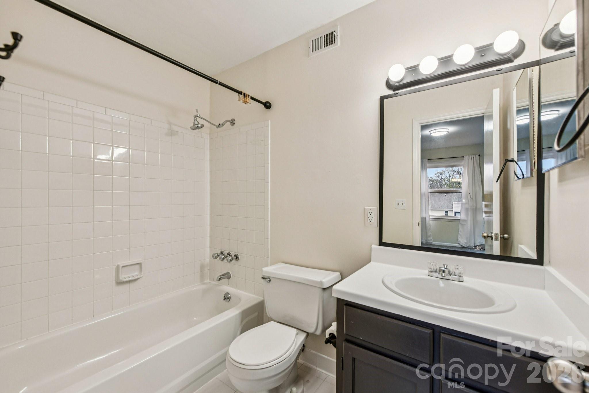 430 Queens Road, Unit 732 Charlotte, NC 28204 - Photo 15 of 17 a bathroom with a sink and a mirror