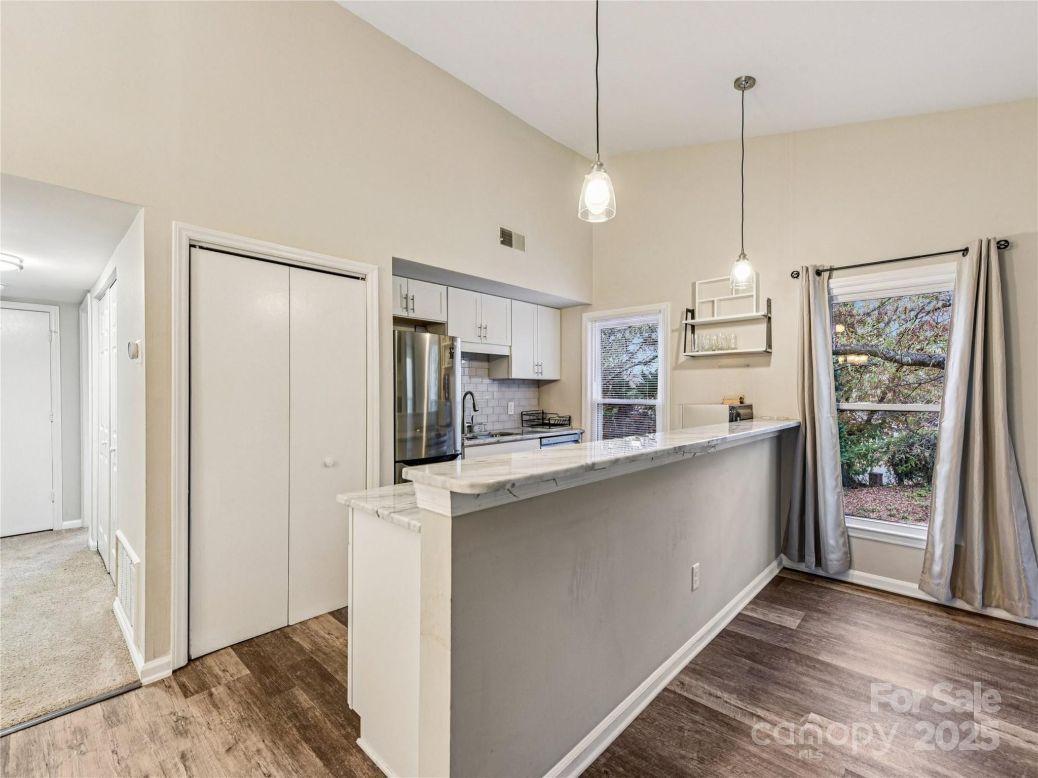 430 Queens Road, Unit 732 Charlotte, NC 28204 - Photo 6 of 17 a kitchen with stainless steel appliances granite countertop a refrigerator a sink and a stove