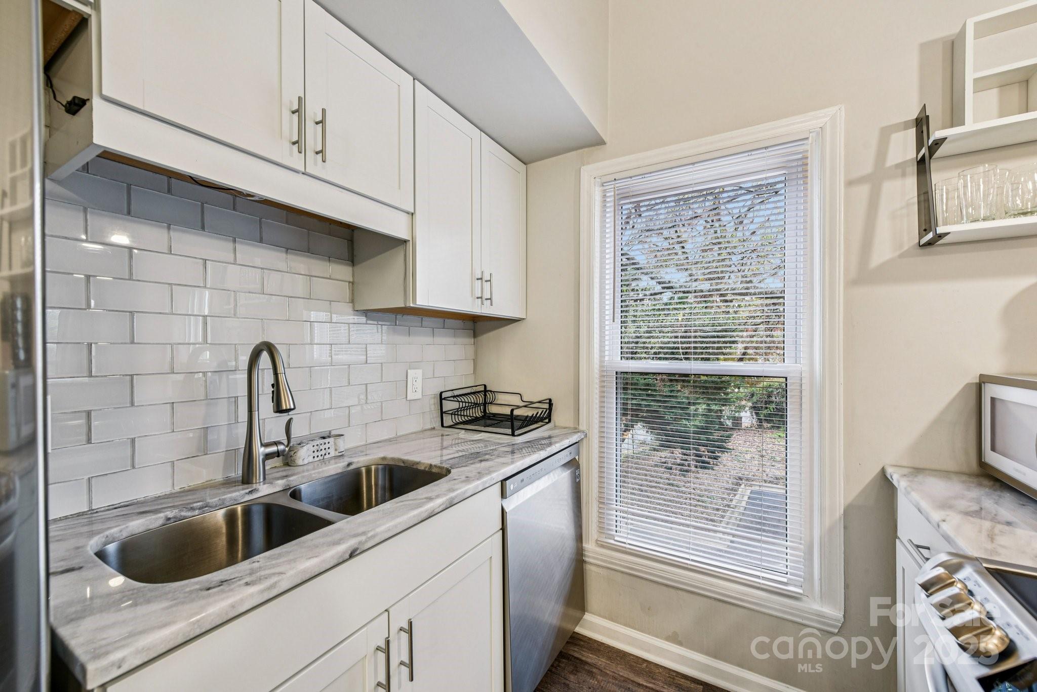 430 Queens Road, Unit 732 Charlotte, NC 28204 - Photo 9 of 17 a kitchen with a sink a stove and cabinets