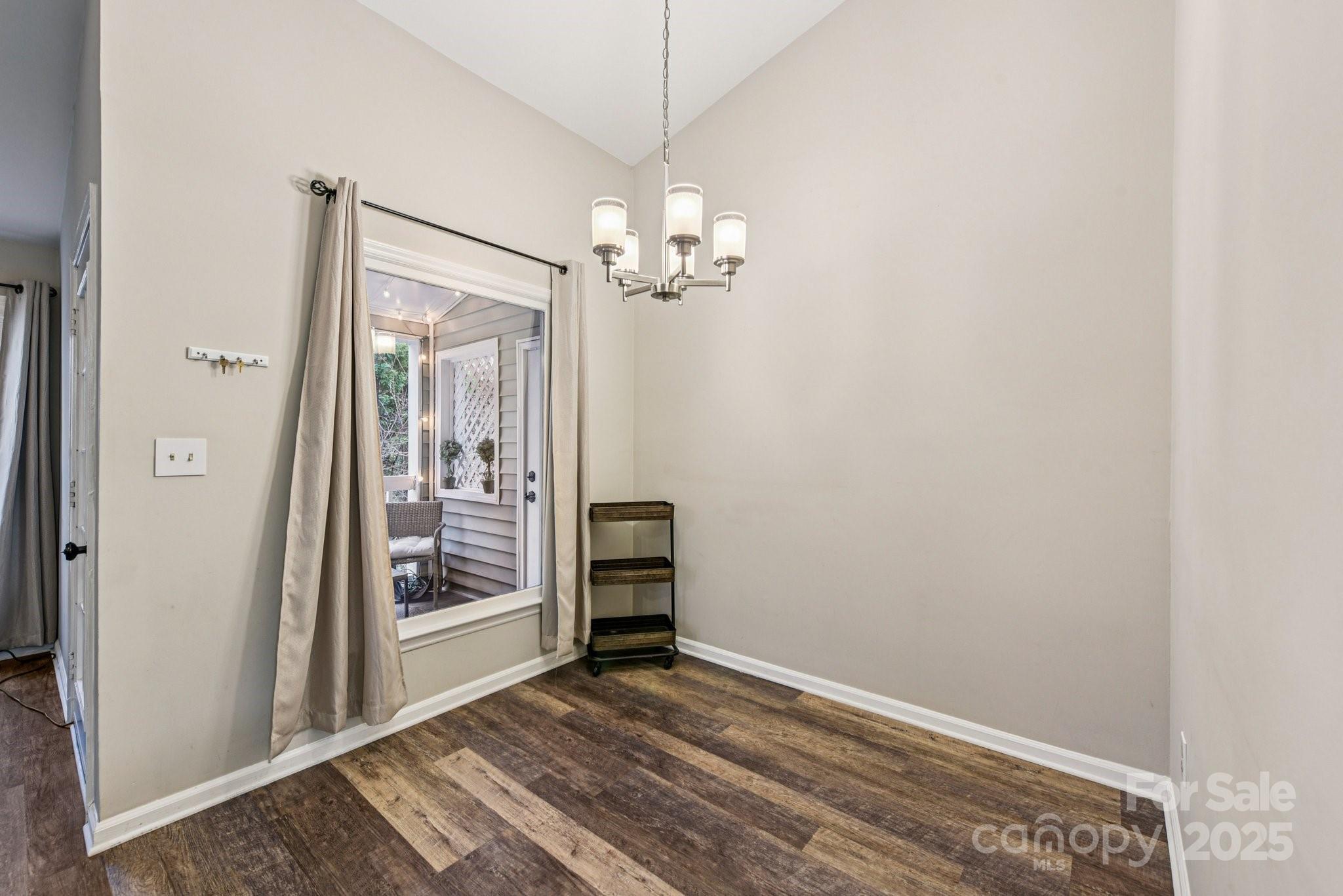 430 Queens Road, Unit 732 Charlotte, NC 28204 - Photo 10 of 17 a view of a chandelier fan and wooden floor