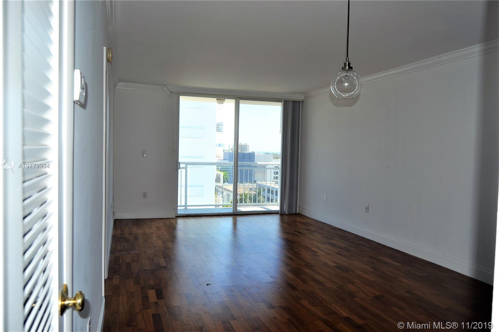 1345 Lincoln Road, Unit 1106 Miami Beach, FL 33139 - Photo 6 of 33 LIVING ROOM WITH IMPACT SLIDING GLASS DOORS