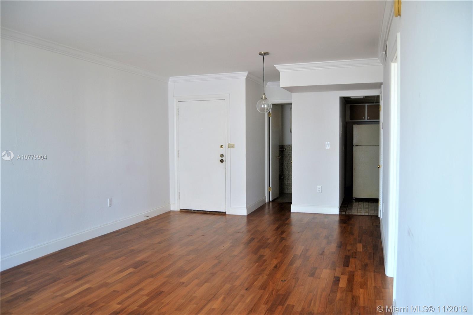 1345 Lincoln Road, Unit 1106 Miami Beach, FL 33139 - Photo 10 of 33 LIVINGROOM WITH BASEBOARDS AND CROWN MOLDING