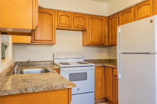 an empty room with wooden floor and closet area