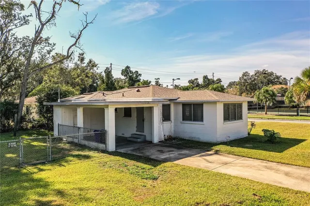 a front view of a house with a yard and trees